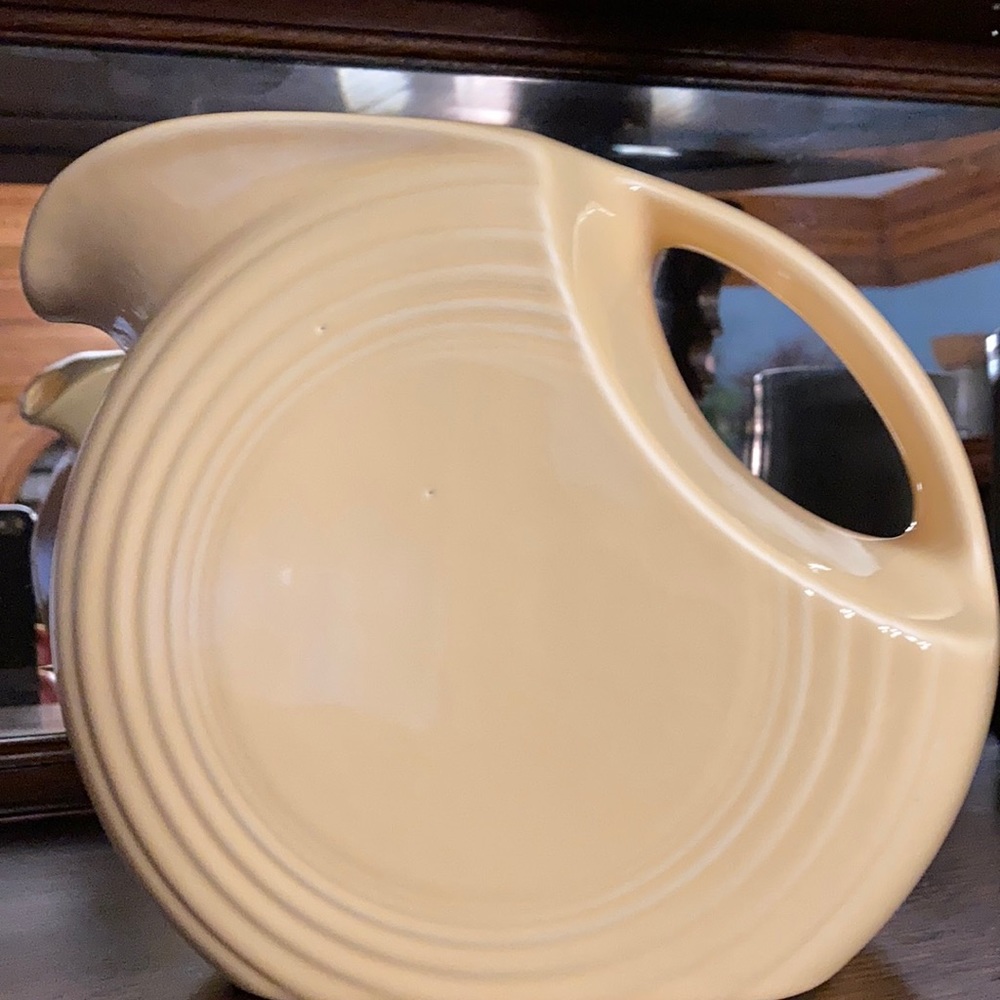 Vintage & retired, this Fiesta ware disc pitcher is a factory second. No damage
